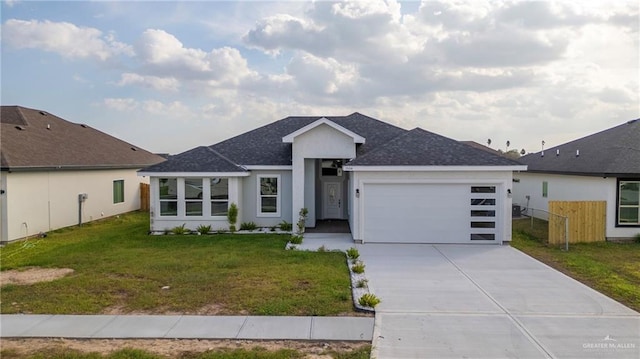 view of front of home with a garage and a front lawn