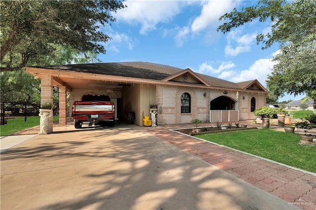 2865 E Mile 9 1/2 N, Donna, TX 78537 - view of front of house featuring concrete driveway, a front lawn, a carport, and brick siding