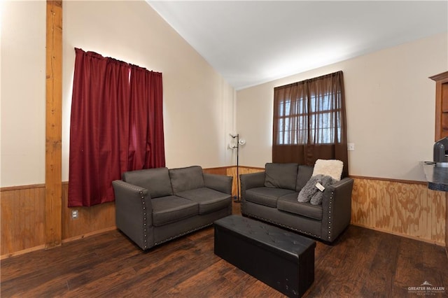 living room with dark hardwood / wood-style flooring, lofted ceiling, and wood walls