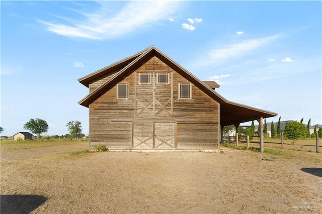 back of house with an outdoor structure