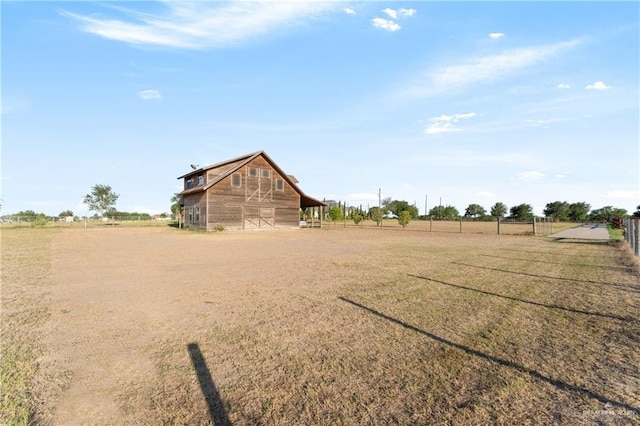 view of yard featuring a rural view and an outdoor structure