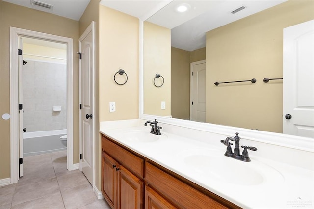 full bathroom with toilet, vanity, tile patterned floors, and tiled shower / bath