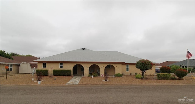 ranch-style home featuring a shed