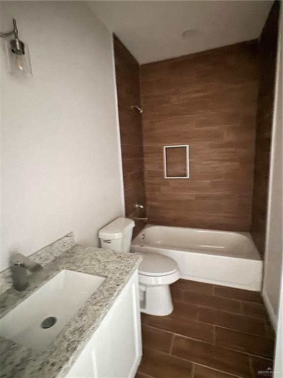 full bathroom with toilet, vanity, and tiled shower / bath combo