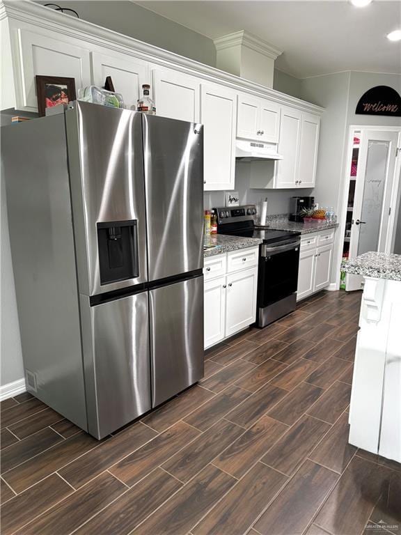 kitchen featuring light stone counters, under cabinet range hood, wood finish floors, white cabinetry, and appliances with stainless steel finishes