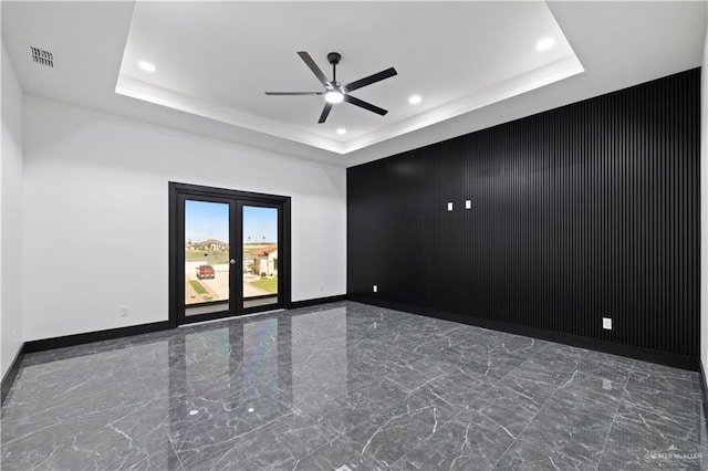 4648 Estancia Pkwy, Mcallen, TX 78504 - spare room with marble tiled floors, a tray ceiling, a ceiling fan, recessed lighting, and an accent wall