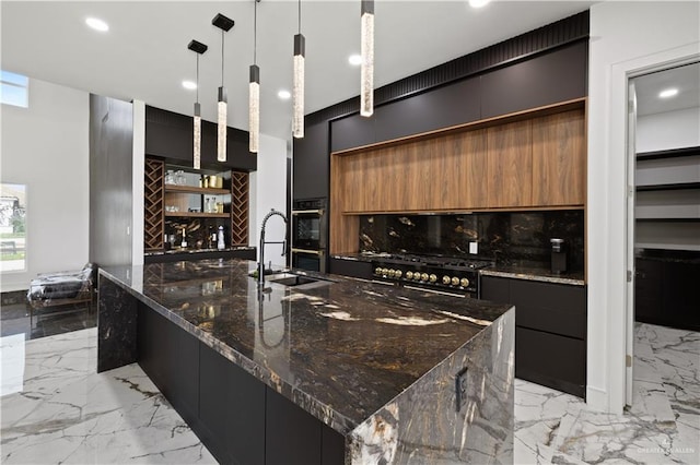 4648 Estancia Pkwy, Mcallen, TX 78504 - kitchen featuring modern cabinets, light marble finish flooring, a large island, dark stone countertops, and brown cabinets