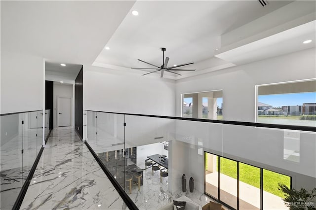 4648 Estancia Pkwy, Mcallen, TX 78504 - corridor featuring a tray ceiling, recessed lighting, and marble tiled floors