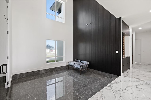 4648 Estancia Pkwy, Mcallen, TX 78504 - unfurnished bedroom featuring marble tiled floors, multiple windows, a high ceiling, and recessed lighting