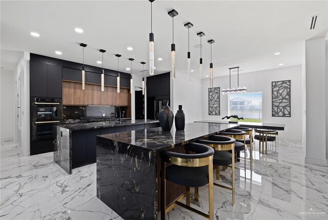 4648 Estancia Pkwy, Mcallen, TX 78504 - kitchen with a spacious island, modern cabinets, light marble finish flooring, recessed lighting, and backsplash