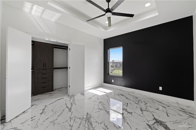 4648 Estancia Pkwy, Mcallen, TX 78504 - unfurnished bedroom featuring a tray ceiling, recessed lighting, light marble finish floors, and ceiling fan