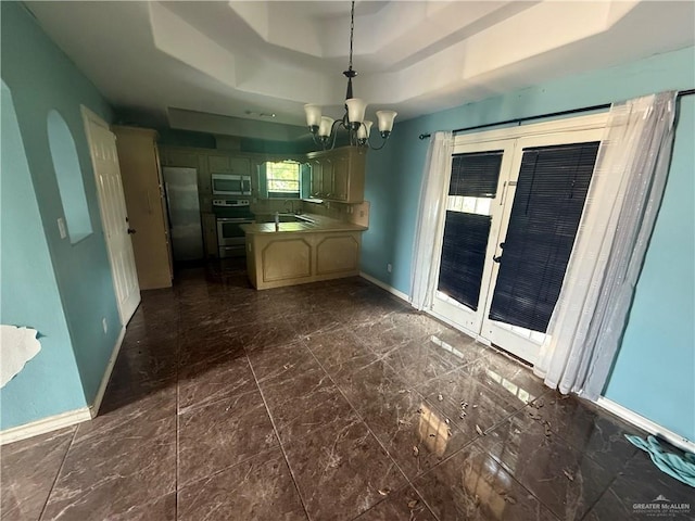 1908 W 42nd St, Mission, TX 78573 - kitchen with stainless steel appliances, baseboards, a peninsula, a chandelier, and a tray ceiling