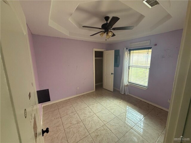 1908 W 42nd St, Mission, TX 78573 - unfurnished bedroom with a raised ceiling, baseboards, light tile patterned floors, and ceiling fan