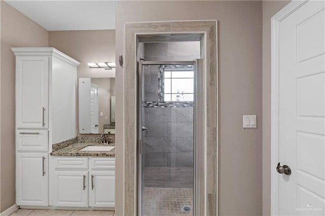 bathroom with tile patterned flooring, vanity, and an enclosed shower