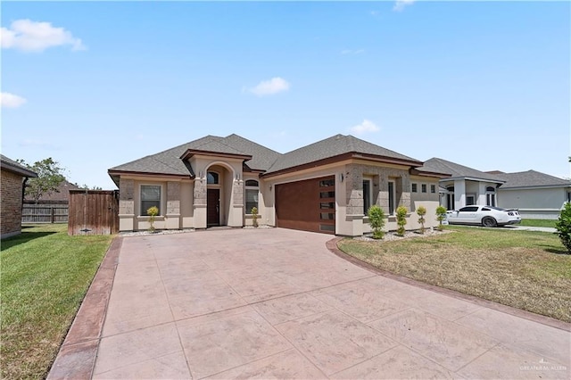 prairie-style home with a front lawn and a garage