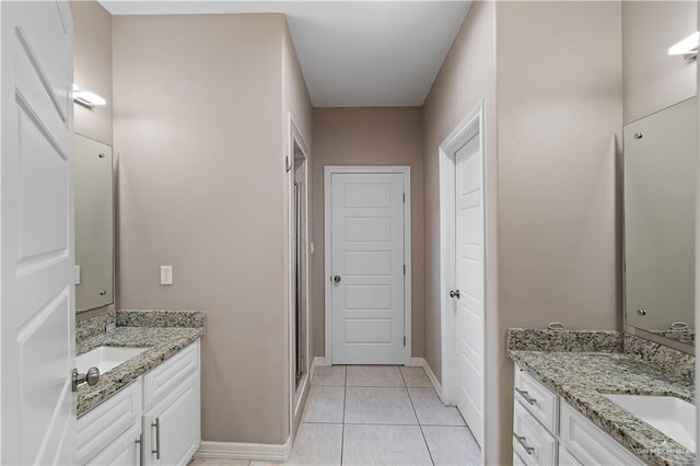 bathroom with vanity, tile patterned floors, and walk in shower