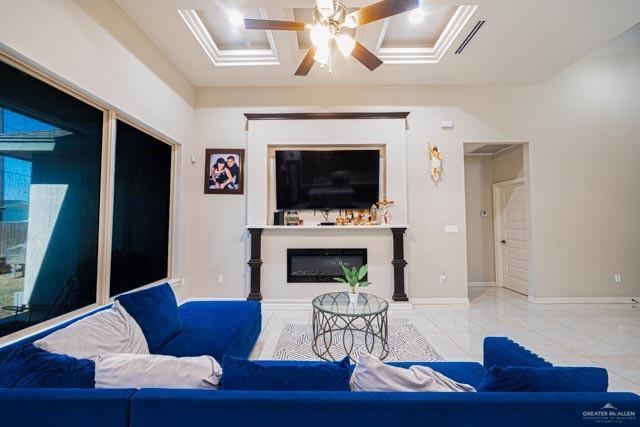 living room with ceiling fan and coffered ceiling