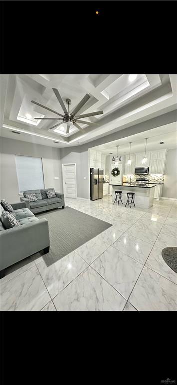 502 Oak Ridge St, Donna, TX 78537 - interior space with marble finish floor, a ceiling fan, and coffered ceiling