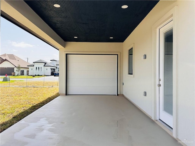 garage featuring concrete driveway