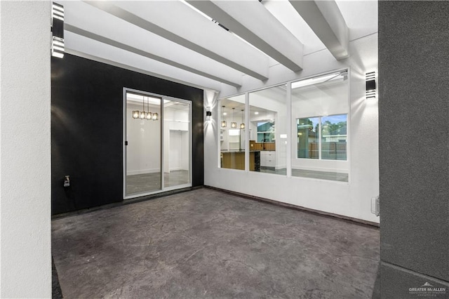 3009 E Bella Vista Ave, Alton, TX 78573 - spare room featuring concrete floors, a textured wall, and beamed ceiling