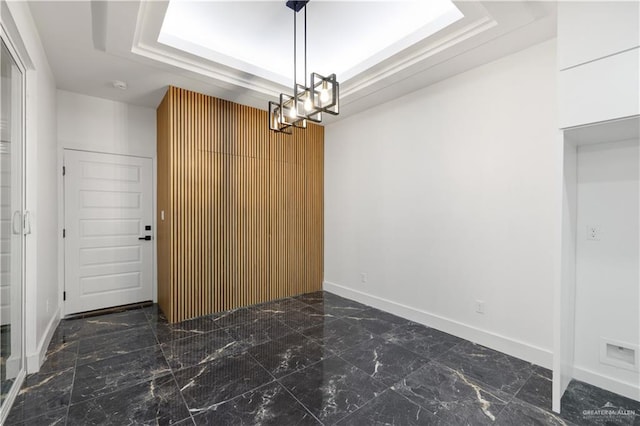 3009 E Bella Vista Ave, Alton, TX 78573 - unfurnished dining area featuring baseboards, marble finish floor, a notable chandelier, and a raised ceiling