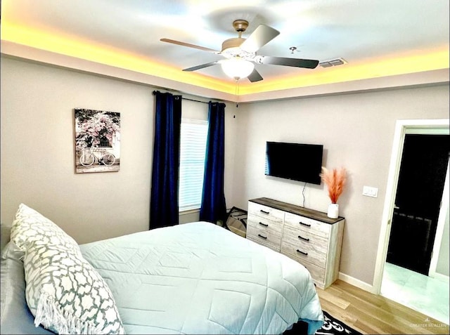 bedroom with light hardwood / wood-style flooring and ceiling fan