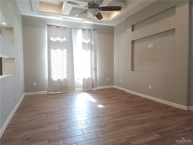 unfurnished room with coffered ceiling, beam ceiling, dark hardwood / wood-style floors, and ceiling fan