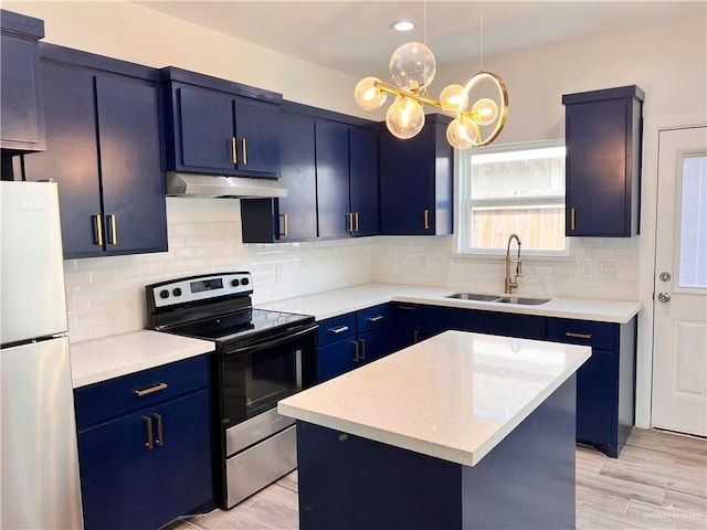 kitchen featuring a sink, stainless steel appliances, light countertops, blue cabinetry, and under cabinet range hood