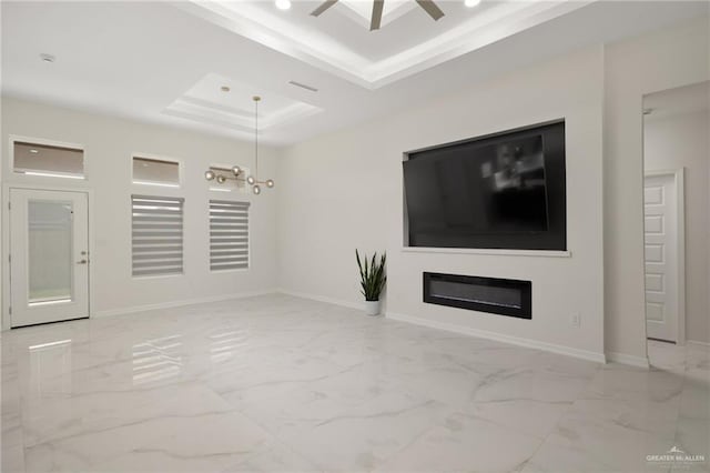 unfurnished living room featuring baseboards, a raised ceiling, marble finish floor, and a ceiling fan