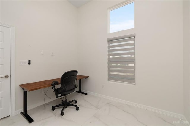 home office with marble finish floor and baseboards