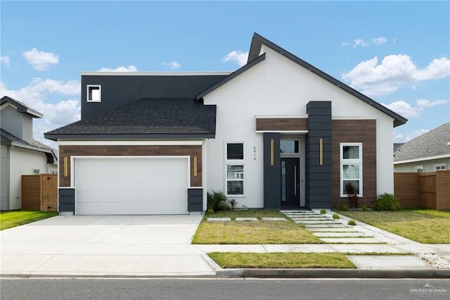 contemporary house featuring fence, a garage, a front lawn, and concrete driveway