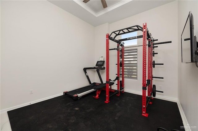 workout room featuring baseboards and a ceiling fan