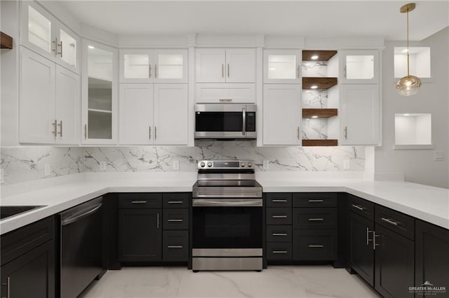kitchen with light countertops, stainless steel appliances, open shelves, and white cabinets