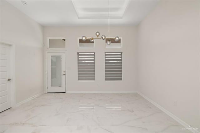 unfurnished dining area with marble finish floor and baseboards