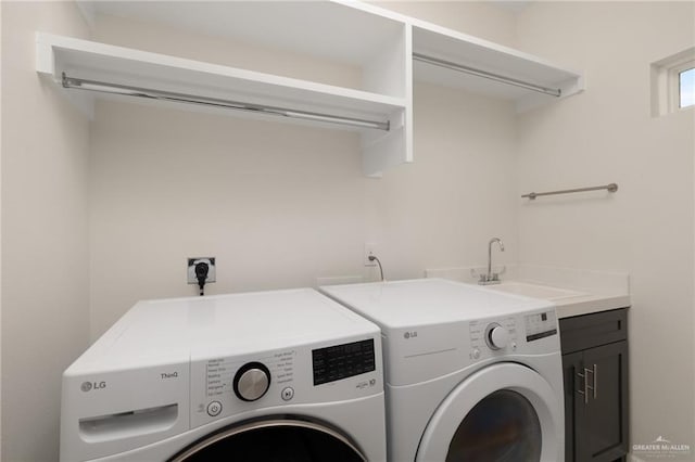 laundry room featuring cabinet space, independent washer and dryer, and a sink