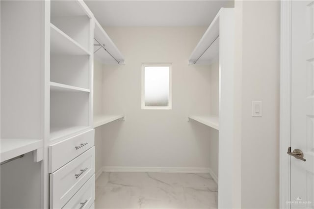 spacious closet with marble finish floor