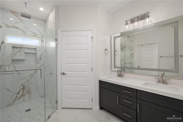 full bath with a sink, double vanity, a marble finish shower, and marble finish floor