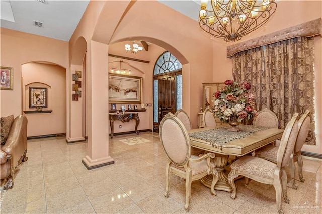 dining area with lofted ceiling and an inviting chandelier