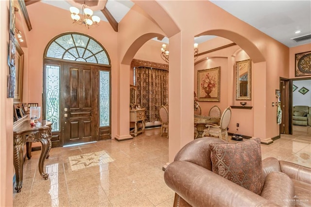 foyer featuring a high ceiling and a notable chandelier