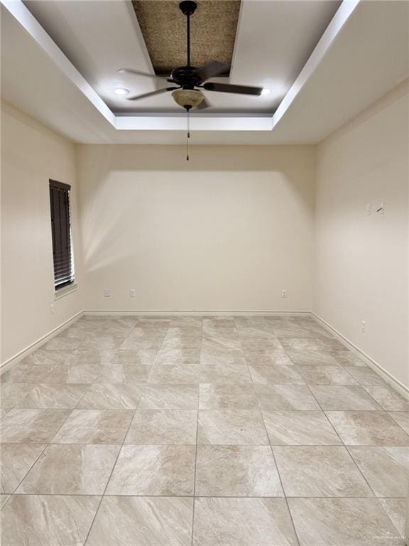 1813 Harvard Ave, Mcallen, TX 78504 - spare room with a raised ceiling, ceiling fan, and baseboards