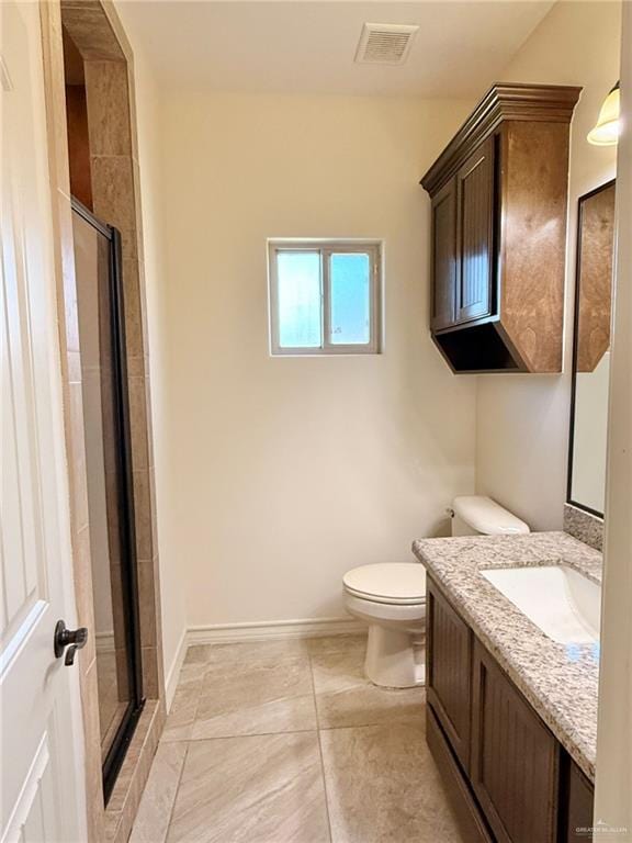1813 Harvard Ave, Mcallen, TX 78504 - bathroom featuring toilet, a shower stall, vanity, tile patterned flooring, and baseboards