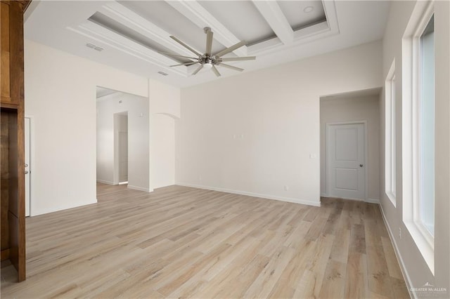 unfurnished room with beamed ceiling, ceiling fan, and light hardwood / wood-style flooring