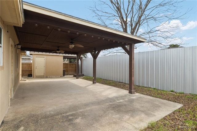 view of patio / terrace featuring a fenced backyard, ceiling fan, and driveway