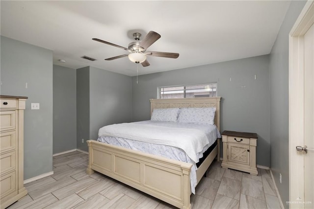 bedroom featuring ceiling fan, visible vents, and baseboards