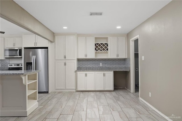 kitchen featuring stainless steel appliances, visible vents, light stone countertops, open shelves, and tasteful backsplash