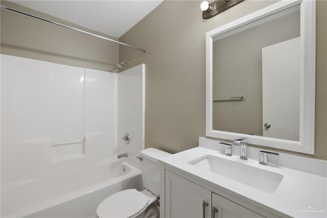 bathroom with tub / shower combination, vanity, and toilet