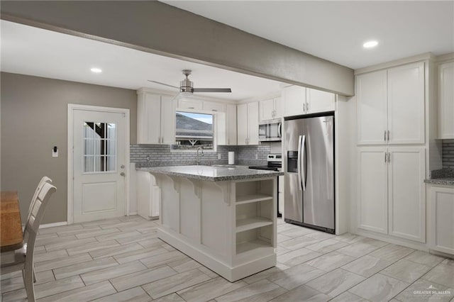 kitchen featuring open shelves, light stone countertops, stainless steel appliances, and decorative backsplash