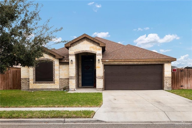 view of front of house featuring a garage and a front yard