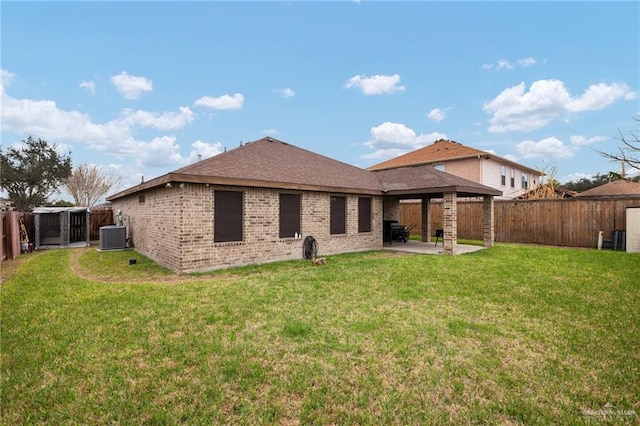 rear view of property with central AC, a lawn, and a patio