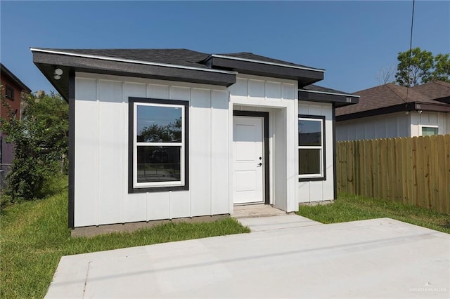 814 N Martinez Ave, Weslaco, TX 78596 - view of front facade featuring board and batten siding, a patio area, and roof with shingles